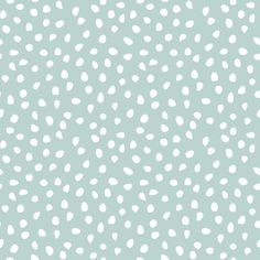 white polka dots on a light green background