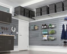 an image of a garage with various items on the wall and in storage bins