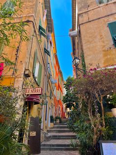 an alleyway with colorful buildings and plants