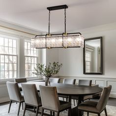 a dining room table with chairs and a chandelier