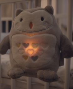 a stuffed animal in the shape of a baby's crib with its eyes open