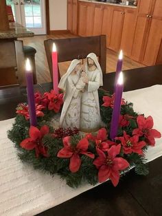 a christmas wreath with candles on top of it