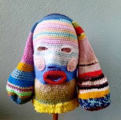 a crocheted stuffed animal with multicolored stripes on it's face