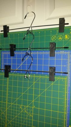 a cutting mat with scissors and other tools hanging from it