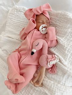 a baby is sleeping on a blanket with a pacifier in its mouth