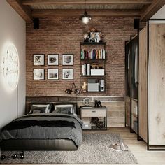 a bedroom with brick walls and wooden flooring is shown in this image, there are pictures on the wall above the bed