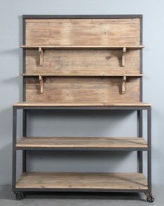 three wooden shelves are stacked on top of each other, with one shelf below them