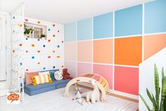 a child's room decorated in pastel colors with toys on the floor and walls