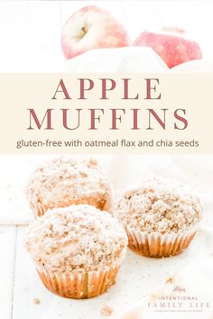 three muffins sitting on top of a table next to an apple