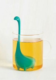 a tea cup with a plastic dinosaur in it