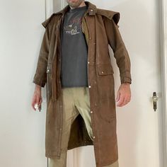 Listed For Sale Here Is A First Genuine Leather Full Length Duster With Liner & Cape Size Small - Model In The Photos Is 6'2" @175lbs Brown Leather Coat With A Removable Thinsulate Liner Two Front Pockets With Snap Shut Flaps Button Snaps All The Way Down The Front In Overall Great Pre-Loved Condition But There A Few Flaws. Some Blemishes To The Leather Here And There, The Largest Of Which Is Just Below And To The Back Of The Left Front Pocket (Seen In The Last Photo) But No Rips Or Tears. See Measurements Below (In Inches) And Compare To Your Favorites At Home. Underarm Width: 24 Waist Width: 23 Length Down Back: 48 Shoulder + Sleeve: 29 Cowboy Duster Coat, Brown Leather Vest Hood, Brown Hooded Leather Outerwear, Brown Leather Outerwear With Stand Collar, Brown Leather Coat, Brown Leather Military Outerwear, Men's Coats And Jackets, Genuine Leather Jackets, Leather Coat