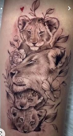 a woman's thigh with two lions and flowers on it