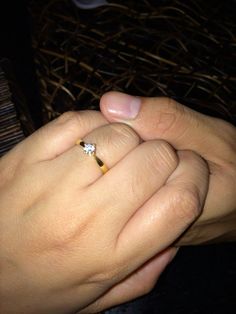 two people holding each other's hands with their wedding rings