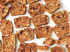 several pieces of bread with nuts and raisins on top