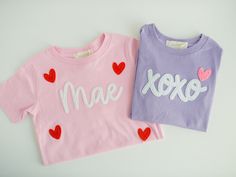 Happy Valentine's Day! We love these xoxo and custom felt name t-shirts! Shirts are available in four different colors. Each design is cut from felt and hand-stitched. These make perfect gifts for the little loves in your life!  Matching custom name hair bows are available here https://www.etsy.com/listing/1631086557/valentine-hand-embroidered-name-hairbow ----- - DETAILS - This listing is for one custom embroidered sweatshirt or t-shirt. Text is created in white felt and is hand-stitched with m Custom Embroidered Sweatshirt, Felt Name, Toddler Valentines, Valentine T Shirts, Heart Shirt, Embroidered Sweatshirt, Happy Valentine's Day, Happy Valentine's