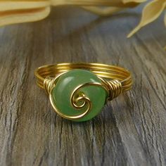 "Green Aventurine Gemstone and Sterling Silver, Yellow or Rose Gold Filled Wire Wrapped Swirl Ring; Custom Made to Size ❀ This round green aventurine gemstone bead and wire wrapped ring is handmade with an approximately 8mm by 5mm bead and your choice of wire for the band. ❀ This ring (as well as all the others in my shop) is custom made to any size from 4 to 14 including half and quarter sizes! ❀ This ring can be made in Sterling Silver Filled Wire, Argentium Sterling Silver wire (tarnish resis Simple Wire Rings, Vitamin B17, Diy Wire Wrapped Rings, Gold Wire Ring, Ring Inspo, Ring Making, Swirl Ring, How To Make Rings, Diy Rings