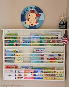 a wall mounted shelf with books and toys on it