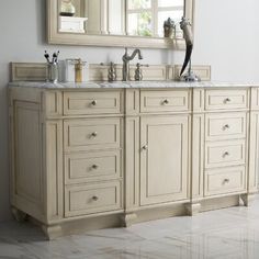 a bathroom vanity with two sinks and a large mirror