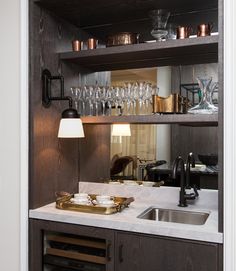 an open cabinet with wine glasses on it