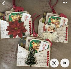 four christmas envelopes with santa claus on the front and one has a red poinsetti