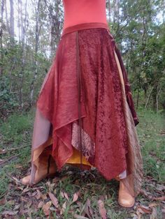 This post features a multi-layered, rust-brown theme wrap skirt. As with all my garments the skirt is a 'one-of-a-kind' design. It incorporates textured and patterned chiffon, velour and printed jersey on a polyester blend lining. Individual fabric pieces were either up-cycled or sourced over the years from end of roll remnants. The theme suits formal and semi-formal events, as well as special day-wear moments. The skirt fits sizes 8 to 18. The length from waist band to longest fabric drop is approximately 102 cm. Garment fastening and size alteration are simply done by choosing appropriately positioned velcro pieces (as shown) and buttons that are sewn on the waist band. Extra buttons or velcro strips can be added if finer adjustments are required.  A few things to consider: *Actual fabri Patchwork Tiered Skirt For Fall, Fall Patchwork Tiered Skirt, Fall Patchwork Asymmetrical Skirt, Bohemian Brown Skirt For Fall, Fall Bohemian Brown Skirt, Bohemian Asymmetrical Skirt For Fall, Hippie Festival Skirt For Fall, Hippie Skirt For Fall Festivals, Bohemian Red Skirt For Fall