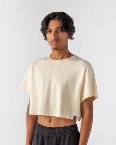 Less Shirt, More Attitude. Inspired by the halcyon days of the 80’s, we’ve managed to make more out of less by cropping our favorite Essentials Tee. Chopped just at the bottom of the rib-cage, this loose fitting crop shares the same luxurious hand feel and drape of our Essentials Tee. Our Essentials Crop is made in North Carolina with plush 8oz cotton interlock fabric and zero plastic for max quality and comfort—and nothing more. Crop Tops Loose, Oversized Cropped Tshirt, Crop Tops Men, Menswear 2024, How To Defend Yourself, Loose Crop Top, Masc Fashion, Mens Crop Top, Outfit Pieces