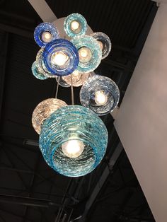 several blue and clear glass lights hanging from the ceiling