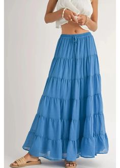 Smocked drawstring waist maxi skirt with many tiers, and a matching lining. Pair with a white tank, cowboy hat, and funky shoes for a concert this summer! Coastal Tiered Maxi Skirt: Blue 100% Polyester Lining Cheap Ruffled Beach Skirt, Cheap Tiered Gathered Maxi Skirt, Cheap Trendy Tiered Skirt, Cheap Green Tiered Skirt, Cheap Lined Skirt For Beach, Cheap Medium Wash Tiered Skirt, Cheap Tiered Cotton Bottoms, Cheap Tiered Skirt For Festival, Cheap Lined Tiered Skirt