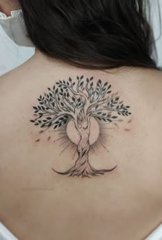 a woman with a tree tattoo on her back