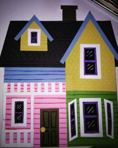 a drawing of a house made out of colored paper