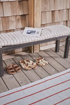 a pair of shoes sitting on top of a wooden bench