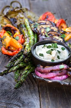 grilled vegetables with ranch dressing on a platter