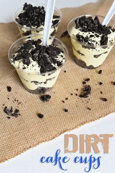 three dessert cups with oreo cookies and cream in them on a burlly cloth