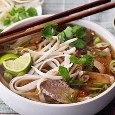 a bowl of soup with noodles, meat and vegetables