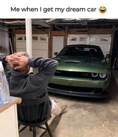 a man sitting at a desk in front of a car with the caption me when i get my dream car