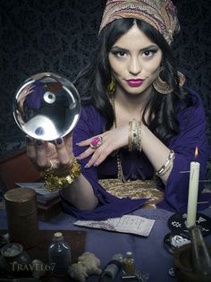 a woman holding a crystal ball in front of her face