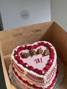 a heart shaped cake in a box with teddy bears on top and the number 11