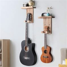 two guitars are hanging on the wall