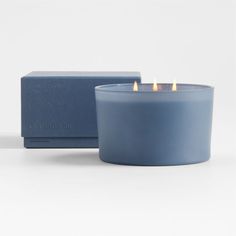 a blue candle sitting next to a box