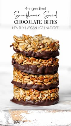 chocolate covered granola bites stacked on top of each other with text overlay that reads 4 ingredient sunflower seed chocolate bites healthy vegan gf