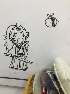 a drawing of a girl holding a knife in front of a wall with drawings on it