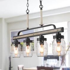 a chandelier with five mason jars hanging from it