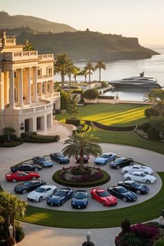 an aerial view of a mansion with cars parked in the driveway and palm trees surrounding it