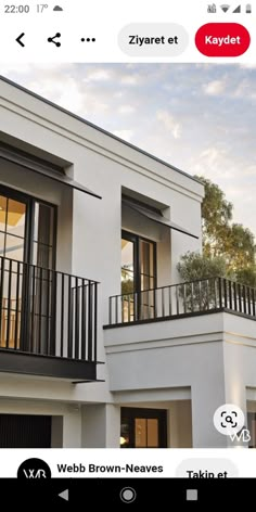 a white house with two balconies and windows