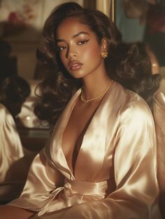 a woman in a satin robe sitting on a chair with her hair blowing in the wind