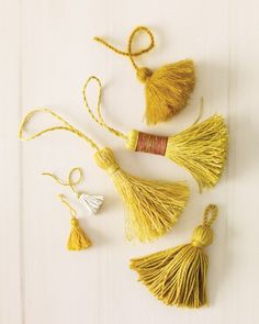 there are three tassels hanging on the wall with words that read, we're making tassels