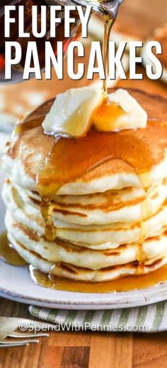 a stack of pancakes with syrup being drizzled on top