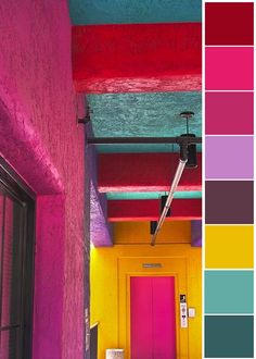 a hallway painted in bright colors with pink, yellow, and green accents on the ceiling