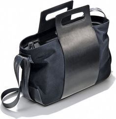 a black and grey bag with a handle on it's side, sitting on a white surface