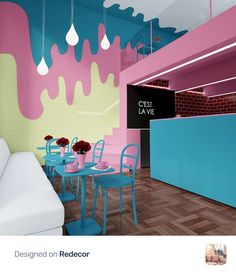 the interior of a restaurant with pink and blue walls